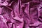 Folded glossy purple viscose fabric from above
