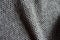 Folded grayish brown woolen fabric with diamond pattern