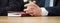 Folded hands of a politician or businessman on a table next to a notepad. Official, boss, lawyer or deputy. Participation in