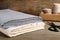 Folded hemp cloths and scissors on wooden table, closeup