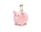 Folded money in piggy bank on white background