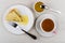 Folded pancake with honey, fork, honey, teaspoon, cup of tea