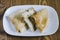 Folded pancake in a plate on a wooden background malaysian delicacies