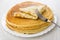 Folded pancake on stack of russian pancakes in dish, fork