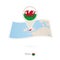 Folded paper map of Wales with flag pin of Wales