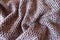 Folded pink, grey and white woolen fabric with diamonds pattern