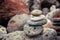 Folded pyramid of smooth stones on the seashore, zen stone