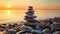 folded pyramid Zen pebble stones on the sea beach at sunset