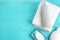 Folded soft towel and toiletries on light blue background. Space for text