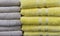 Folded terry towels beige and yellow on the counter of the store. Background of towels