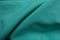 Folded thin bluish green chiffon fabric