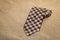 Folded tie with a cheerful pattern on the old tissue