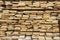 Folded wooden brown and gray planks in a sawmill. Piled alder boards as texture