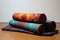 folded yoga blanket, bolster, and meditation cushion