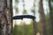 Folding tactical knife stuck in a pine tree in the forest