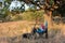 Folding tourist chair, coach, guitar, picnic and relaxing things under the old oak outdoors in the forest