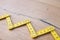 Folding zig zag ruler. Measuring tape folding yellow open in zigzag tips on a workbench. Measuring tools for carpenters and