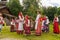 Folk festival dedicated to the Holy Trinity at the Museum of wooden architecture of Vitoslavlitsa. Girls in traditional sundresses