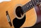 Folk guitar close-up with bridge, strings, other guitar  details
