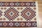 Folk seamless geometric pattern ornaments on the carpet. Traditional carpet design