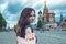 Follow me, Attractive brunette girl holding the hand leads to the red square in Moscow. Russia.