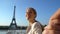 Follow me Paris happy woman leading her boyfriend to Eiffel Tower