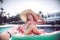 Follow me Vacation concept. Summer holiday by the pool . Woman relaxes on an inflatable circle