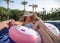 Follow me Vacation concept. Summer holiday by the pool . Woman relaxes on an inflatable circle