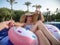 Follow me Vacation concept. Summer holiday by the pool . Woman relaxes on an inflatable circle