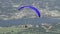 Follow shot of a paraglider launching into flight