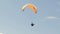 Follow shot of a paraglider launching into flight