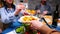 Follow shot of young man serving his sister with potatoes