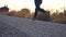 Follow to feet of young girl running at country road. Female leg jogging in nature. Sporty active lifestyle. Slow motion