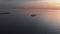 Follow white ship yacht - Aerial sunset top Lighthouse view with ships in the background - Warm setting sun landscape