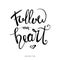 Follow your heart. Modern brush hand drawn ink calligraphy with heart shape.