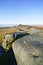 Following the ridge line of Stanage Edge on a hazy, cloudless winter morning.