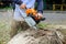 Following a violent storm, a municipal worker cuts down a broken tree