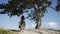 Following woman with hat on beach