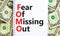FOMO fear of missing out symbol. Concept words FOMO fear of missing out on note on beautiful white background. Dollar bills.