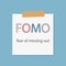 FOMO fear of missing out written in a notebook paper