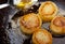 fondant potato frying in sauce pan. butter basting food with spoon whilst cooking. gourmet restaurant dish