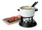 Fondue pot with oil and raw meat on white