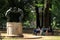 Fontana della famiglia dei Satiri in Villa Borghese garden with three women reading on the bench nearby