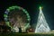 Fonte Nova`s garden with Christmas market and colored ferris wheel near Ria de Aveiro at night