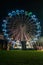 Fonte Nova`s garden with Christmas market and colored ferris wheel near Ria de Aveiro at night