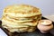 Food. Appetizing baked thick yeast pancakes are stacked on a plate on the table.