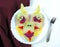 Food art creative concepts.  on a white plate a strange funny face made from white bread, cheese, decorated with chopped beets a