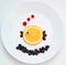 Food art. Little fish from fruit, creative idea for healthy breakfast on the white plate