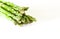 Food background asparagus flat lay pattern. bunch of fresh green asparagus on white background, top view