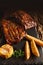 Food background of BBQ barbeque pork ribs served with potato fried and baked corn, selective focus